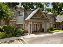 Charming townhome with brick facade, inviting entrance, and well-maintained landscaping at 149 Rondak Se Cir, Smyrna, GA 30080