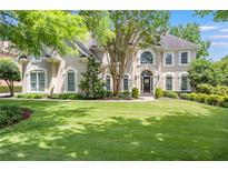 Stunning two-story home featuring a lush lawn and mature trees in a desirable neighborhood at 5600 Buck Hollow Dr, Alpharetta, GA 30005