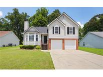 Charming two-story home featuring a well-manicured lawn and an attached two-car garage at 1093 Athena Ct, Acworth, GA 30101