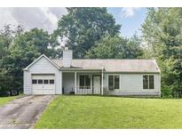 Classic one-story home with an attached garage and a well-maintained front lawn, creating a welcoming curb appeal at 504 Azalea Ct, Woodstock, GA 30188