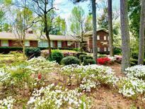 Beautiful brick home with mature landscaping and colorful azaleas in the front yard at 1534 Cooper Lake Se Rd, Smyrna, GA 30082