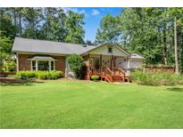 Expansive, well-manicured backyard with a charming deck, perfect for outdoor gatherings and relaxation at 435 Old Holly Rd, Milton, GA 30075
