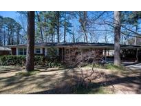 Charming single story home with mature landscaping, carport and red brick exterior at 1288 Skyview Sw Cir, Mableton, GA 30126