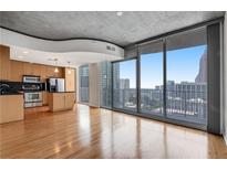 Bright living space with hardwood floors, open to kitchen with stainless steel appliances and a stunning city view at 860 Peachtree Ne St # 1912, Atlanta, GA 30308