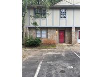 Charming townhome featuring a stone facade, neutral siding and a red front door at 1150 Rankin Street # D1, Stone Mountain, GA 30083