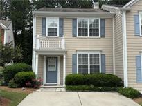 Inviting home with blue shutters, a charming front porch, and well-maintained landscaping at 4172 Howell Park Road, Duluth, GA 30096