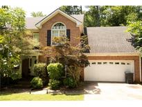 Charming brick home with a well-maintained lawn and mature landscaping, showcasing curb appeal at 1473 Wildwood Way, Hampton, GA 30228