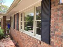 Classic brick home featuring shuttered windows, adding character and charm to the exterior at 3746 Gladney Dr, Atlanta, GA 30341