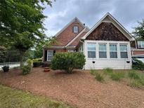 Charming home featuring brick and shake siding, manicured landscaping, and a cozy, inviting front yard at 1604 Haven Cir, Douglasville, GA 30135
