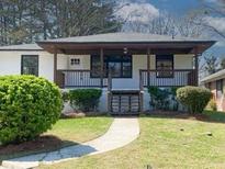 Charming single-story home with a welcoming front porch and well-maintained landscaping at 662 Gary Nw Rd, Atlanta, GA 30318