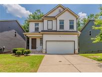 Charming two-story home featuring a two-car garage, well-maintained lawn and craftsman-style details at 173 Parkview Place Dr, Mcdonough, GA 30253