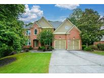 Charming brick home with well-manicured lawn, two-car garage and inviting curb appeal at 3423 Mulberry Lane Ct, Dacula, GA 30019