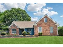 Charming brick home with manicured lawn and garden beds, showcasing curb appeal and a welcoming facade at 4369 Milford Pl, Hoschton, GA 30548