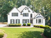 Charming two-story home with a well-manicured lawn and lush landscaping at 1630 Reindeer Rdg, Alpharetta, GA 30005
