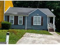 Charming single-story home featuring a well-maintained lawn and a private driveway at 6470 Bedford Ln, Lithonia, GA 30058