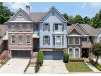 Charming townhome with a well-manicured front yard, neutral palette, and covered front porch at 196 Mystic Ct, Atlanta, GA 30342