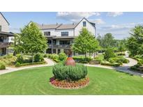 Beautifully landscaped front yard with walking paths and green spaces at this charming residence at 6930 Whitman Walk, Alpharetta, GA 30005