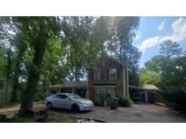 Two-story home with wood siding and a car parked out front at 1383 Natchez Sw Trce, Marietta, GA 30008
