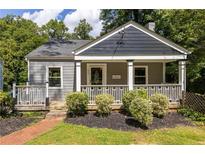 Charming home with a welcoming front porch and manicured landscaping at 217 Rockyford Ne Rd, Atlanta, GA 30317