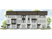 Attractive townhome showcasing a timeless brick facade, black window frames, and professionally landscaped yard at 404 Nix Ln, Lawrenceville, GA 30046