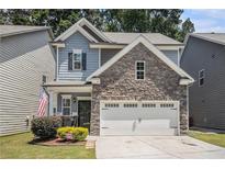 Charming two-story home featuring stone accents, a two-car garage, and well-maintained landscaping at 1232 Candler Ct, Morrow, GA 30260
