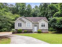 Charming one-story home featuring a well-manicured lawn, mature trees, and a welcoming front entrance at 3514 Blackberry Se Ln, Conyers, GA 30094