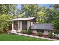 Stunning exterior elevation of home with brick and siding under lush trees at 3282 Leslie Court Northeast Ne Ct, Atlanta, GA 30345