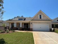 Charming, new construction, one-story home with a welcoming front porch and attached two-car garage at 341 Brooke View Trail, Canton, GA 30115