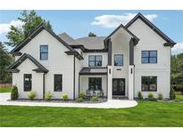Stunning two-story home with black-framed windows and doors, set on a lush green lawn at 4292 Sardis Church Rd, Buford, GA 30519