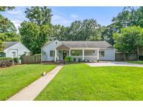 Charming single-story home with a well-manicured lawn and inviting front porch at 1895 Flat Shoals Se Rd, Atlanta, GA 30316