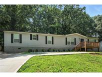Charming single-story home with a well-manicured lawn and inviting entryway at 55 Forest Rd, Stockbridge, GA 30281
