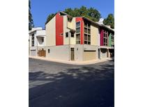 View of the colorful townhome featuring garage and ample windows at 1400 Peter Haughton Nw Way, Atlanta, GA 30318