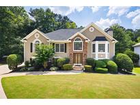 Charming traditional home with well-manicured lawn and lush landscaping providing great curb appeal at 1811 Ascot Nw Cv, Acworth, GA 30102