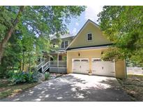 Charming two-story home with a two car garage and beautiful landscaped front yard at 6380 Concord Rd, Cumming, GA 30028