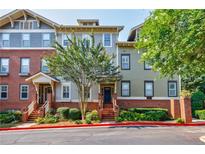 Charming townhouse exterior with brick accents and landscaped entrance at 655 Mead Se St # 3, Atlanta, GA 30312