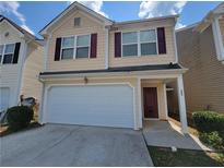 Inviting two-story home featuring a two-car garage and cozy front porch at 285 Fieldview Ln, Covington, GA 30016