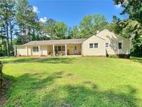 Charming single-story home with a well-manicured lawn and covered front porch at 7680 Banks Mill Road Rd, Douglasville, GA 30135