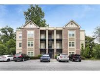 Brick apartment building featuring two stories, balconies, and a well-maintained parking lot at 1903 Anjaco Rd # 5, Atlanta, GA 30309