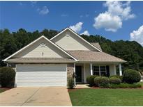 Charming single-story home featuring a two-car garage, well-maintained lawn, and traditional architectural details at 345 Annslee Circle Cir, Loganville, GA 30052