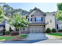 Charming brick two-story home with a well-manicured lawn and a two-car garage at 4335 Bellview Ln, Duluth, GA 30097