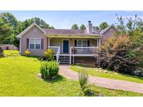 Charming home with a welcoming front porch and well-maintained landscaping at 80 Jacob Trl, Rockmart, GA 30153