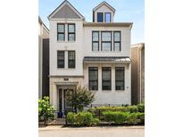 Charming two-story home with white brick exterior, black-framed windows, and professional landscaping at 506 Broadview Ne Pl, Atlanta, GA 30324