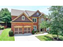 Beautiful two-story home featuring brick and stone accents, well-manicured lawn, and a two-car garage at 5485 Sandstone Ct, Cumming, GA 30040