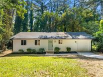 Charming, remodeled single-story home with beautiful lawn, fresh paint, updated landscape, and driveway at 4059 Big Valley Trl, Stone Mountain, GA 30083