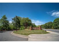 Welcoming entrance to Country Place with brick signage, landscaping and well-maintained grounds on a beautiful, sunny day at 31 Country Place Ct, Alpharetta, GA 30005