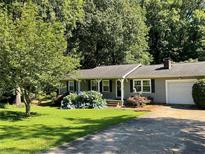 Charming single-story home featuring a well-manicured lawn and a one-car garage at 2832 Jordan Forest Trail Northwest, Lawrenceville, GA 30044
