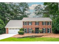Charming brick home with manicured lawn and attached two car garage at 3375 Rivendell Ct, Roswell, GA 30075