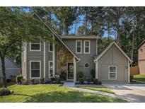 Charming two-story home featuring a stone accent wall, lush lawn, and inviting curb appeal at 5086 N Woodbridge Trl, Stone Mountain, GA 30088