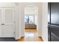 Bright condo hallway featuring hardwood floors and an archway to a living room with city views at 3445 Stratford Ne Rd # 2409, Atlanta, GA 30326
