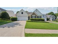 Charming one-story home with a manicured lawn, two-car garage, and stone detailing at 6755 Waveland Dr, Cumming, GA 30040